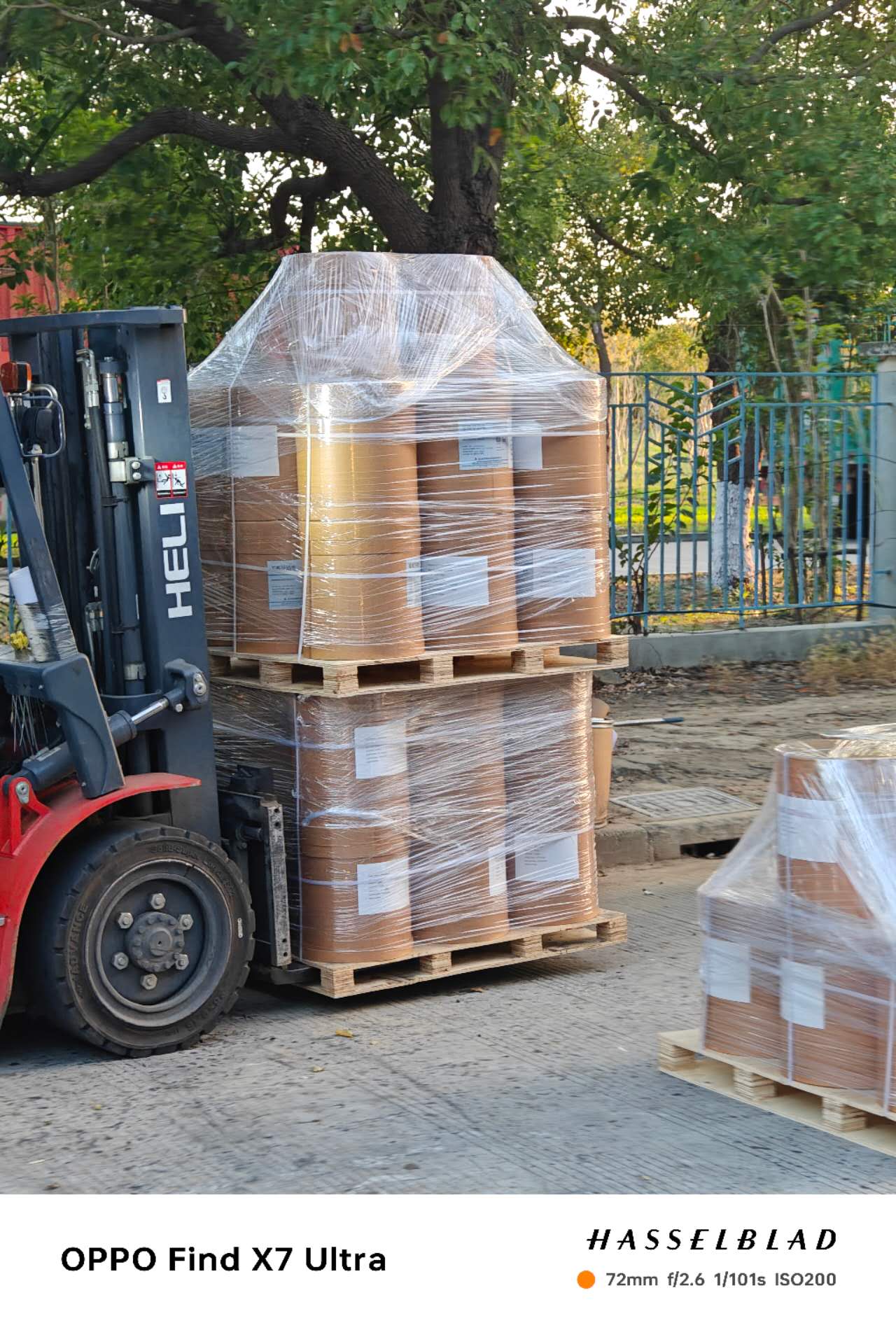 Wrapped chemical products on pallets being handled by forklift